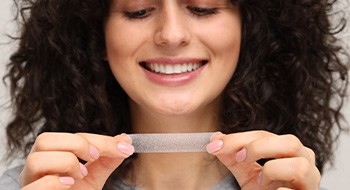 Woman using a whitening strip