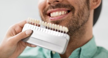 a patient smiling while starting cosmetic dental treatment