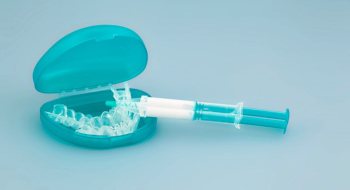 an at-home teeth whitening tray and syringe