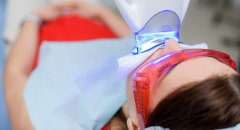 a patient undergoing in-practice teeth whitening treatment