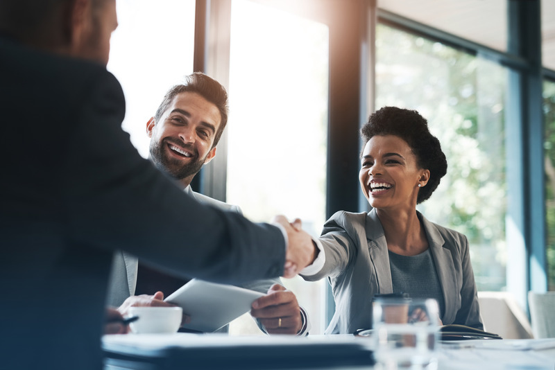 Patient shaking hands with new employer after teeth whitening